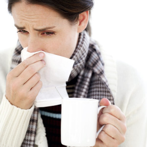 Sick 300x300 - Woman Holding a Mug with a Handkerchief to Her Nose